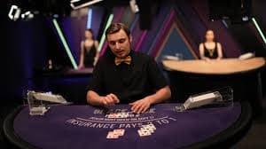 alpaslot777 app showing live-casino blackjack table with dealer, cards, and player betting area on a mobile phone screen in landscape orientation